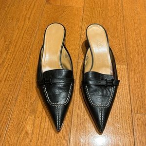 Black leather pointed toe open back peg heel shoes